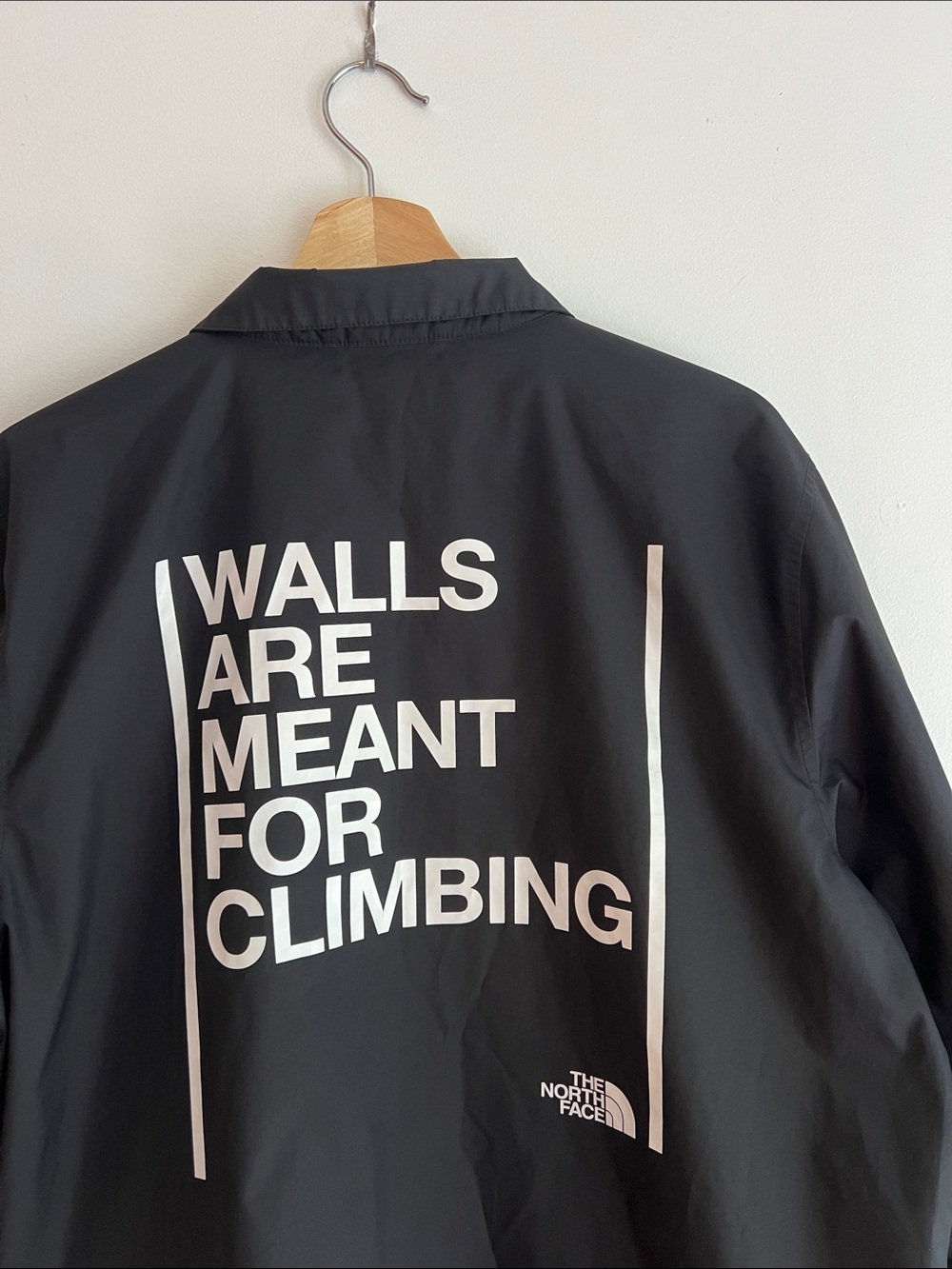 The North Face Black Jacket with White 'Walls Are Meant For Climbing' Graphic
